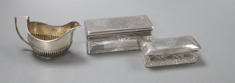 A Victorian silver mounted cut glass toilet jar, of rectangular form, with hinged lid, 9.75cm, a later lidded jar, 8cm and a cream jug